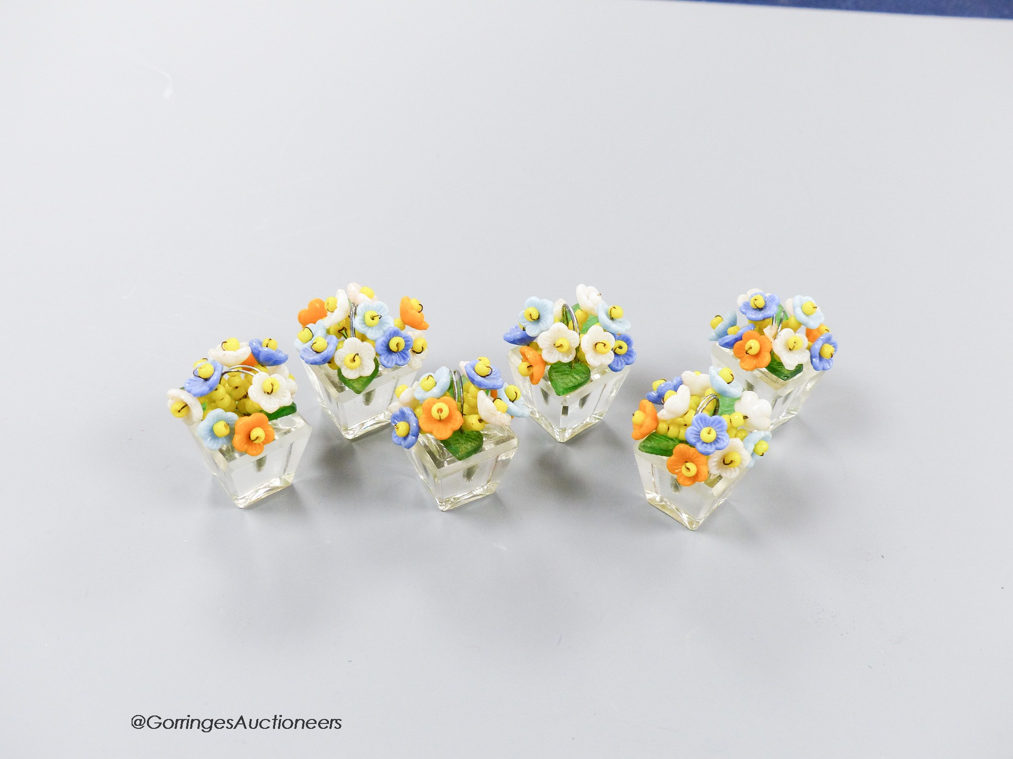 A boxed set of six Czechoslovakian glass flower menu holders, height 3.5cm